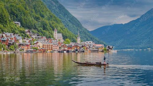 The boatmen of Hallstatt glide silently across the crystal-clear waters of Lake Hallstatt, their wooden boats reflecting the stunning alpine peaks that surround the village. With a deep connection to the lake and its timeless beauty, they offer visitors a serene and intimate way to experience this UNESCO World Heritage site, where tradition and nature coexist in perfect harmony.