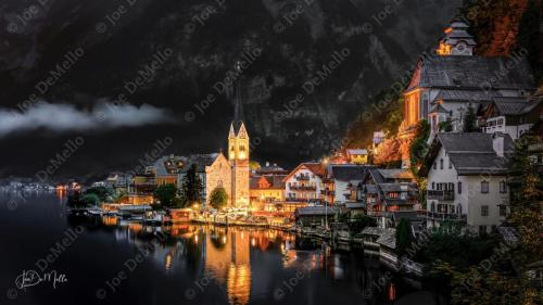 In the evening, Hallstatt transforms into a tranquil, fairy-tale village set against the stunning backdrop of the Dachstein mountains. As the sun sets, the quaint streets and traditional wooden houses are bathed in soft, golden light, reflecting off the serene waters of Lake Hallstatt. The peaceful ambiance, combined with the village's rich history and breathtaking scenery, makes it an enchanting destination for an evening stroll.