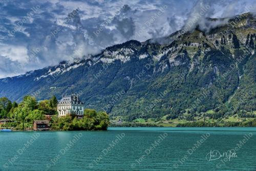 Schloss Seeberg, a fairy-tale castle nestled by a peaceful lake in Switzerland, is surrounded by lush greenery and towering Alps. Its medieval charm and serene atmosphere make it a magical escape, offering a glimpse into a world of timeless beauty and romance.