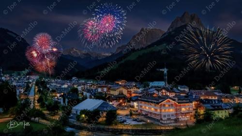In the evening, San Giovanni di Fassa, nestled in the heart of the Dolomites, comes alive with a peaceful, mountain charm. As the sun sets behind the towering peaks, the village's traditional wooden chalets and alpine streets are bathed in soft golden light.